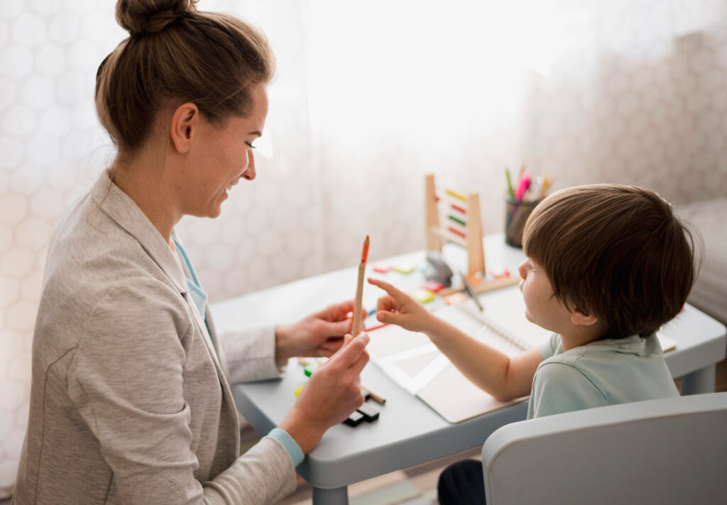 Therapist taking notes while observing child play for a behavioral assessment