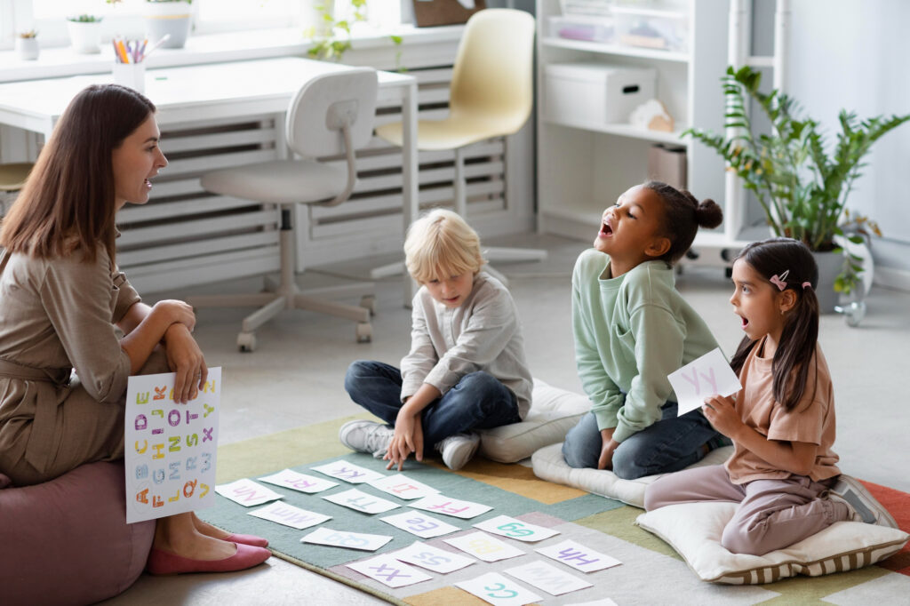 Children practicing social skills in a small therapy group led by a facilitator